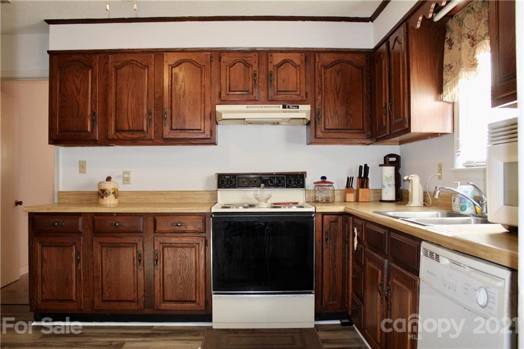 2411 Poors Ford Road Rutherfordton, NC 28139 - Photo 5 of 19 a kitchen with stainless steel appliances granite countertop a sink stove and cabinets