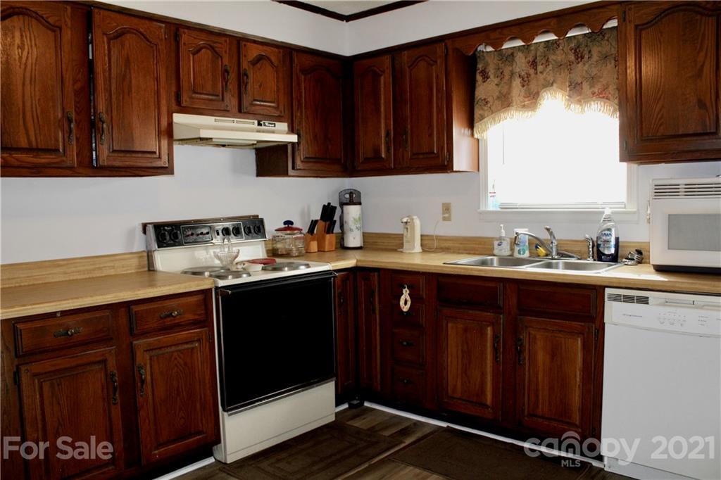 2411 Poors Ford Road Rutherfordton, NC 28139 - Photo 8 of 19 a kitchen with granite countertop wooden cabinets and sink