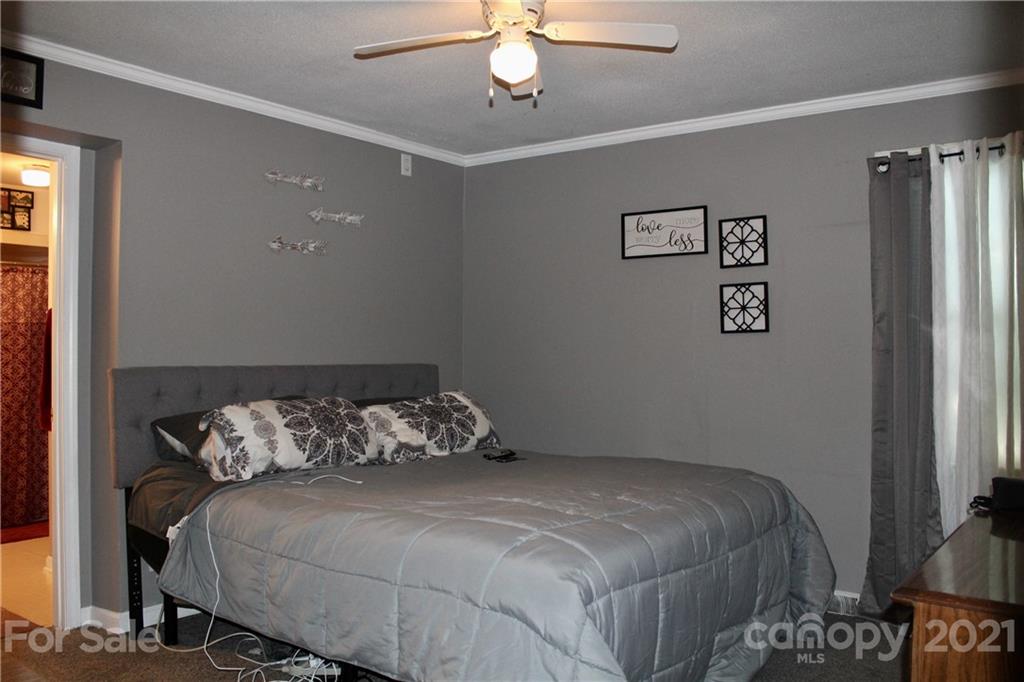 2411 Poors Ford Road Rutherfordton, NC 28139 - Photo 10 of 19 a bedroom with a bed and a chandelier