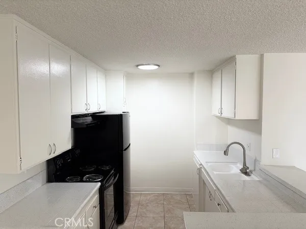 a kitchen with a sink and a refrigerator