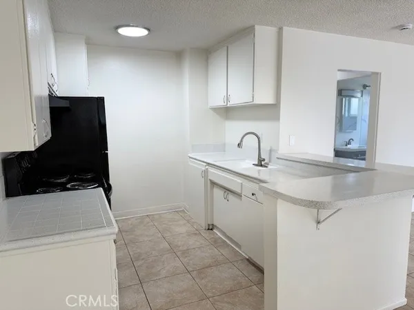 a kitchen with a sink and a stove top oven