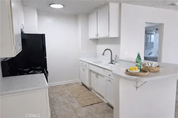 a kitchen with a sink and a stove top oven