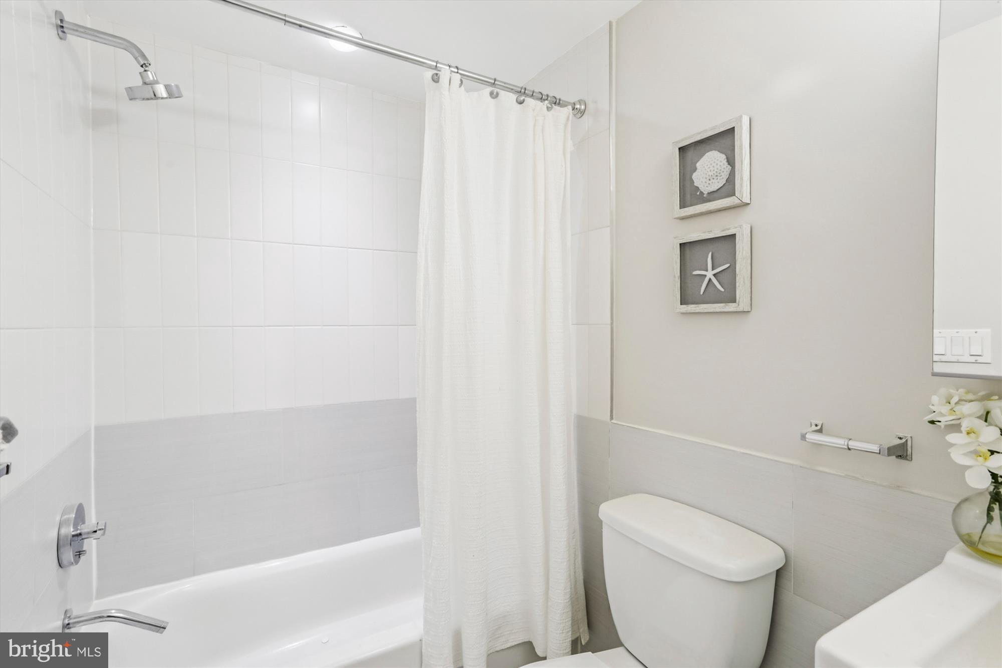 3222 13th Street Northwest, Unit 2 Washington, DC 20010 - Photo 12 of 52 a white toilet sitting next to a bath tub