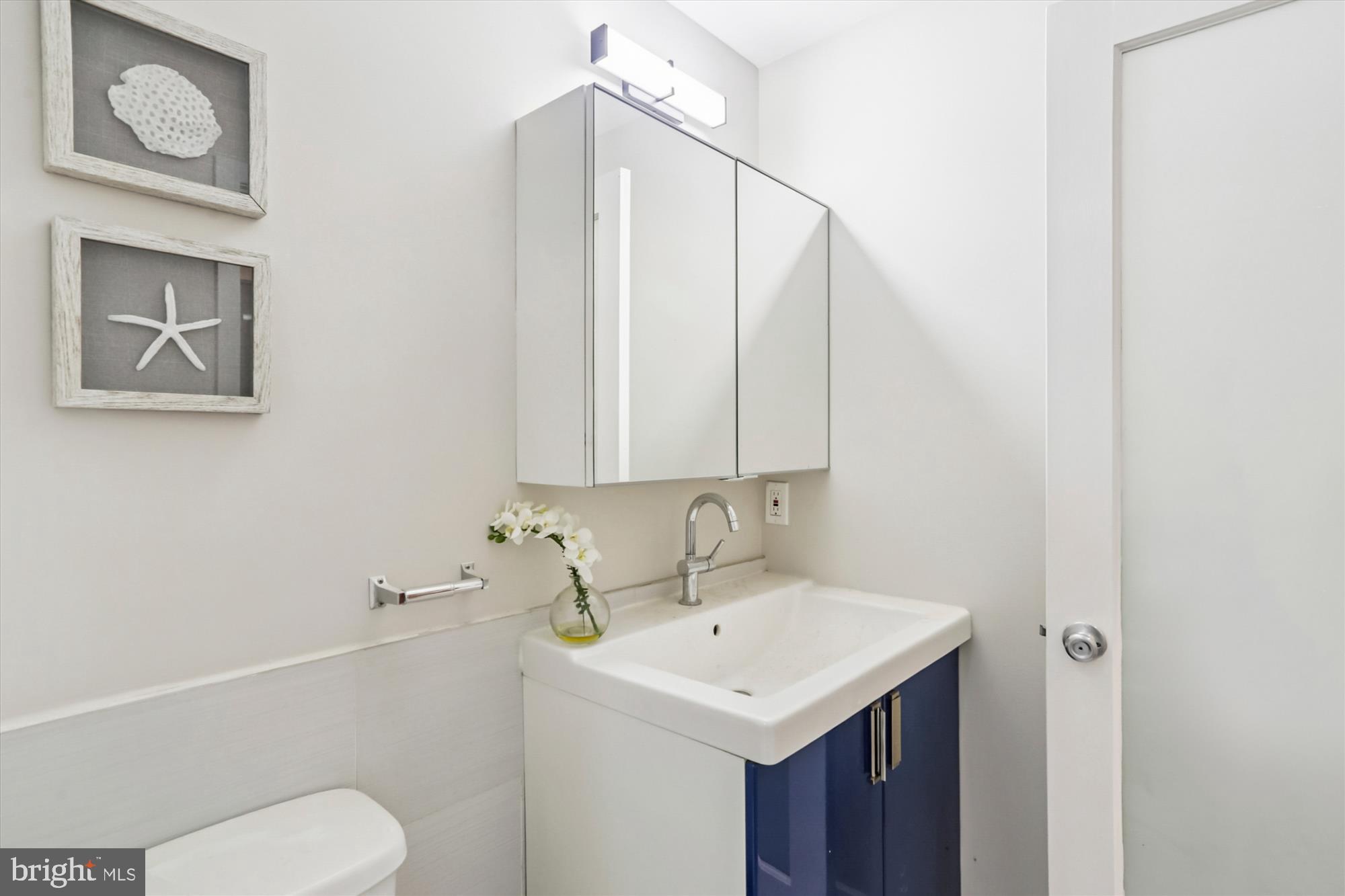 3222 13th Street Northwest, Unit 2 Washington, DC 20010 - Photo 13 of 52 a bathroom with a sink a toilet and mirror