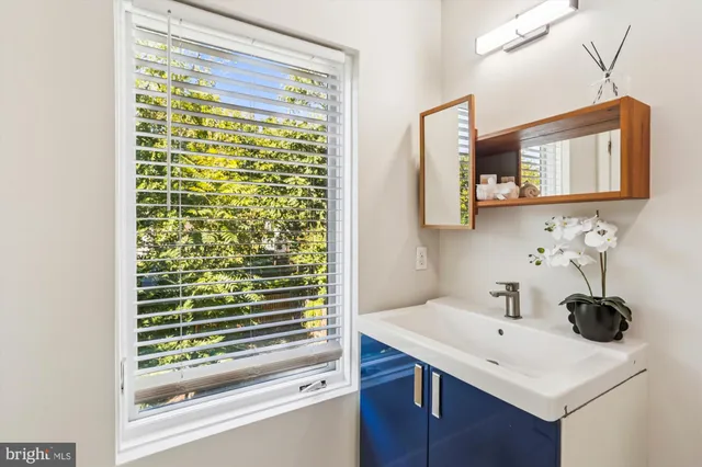 a bathroom with a toilet a sink a mirror and vanity