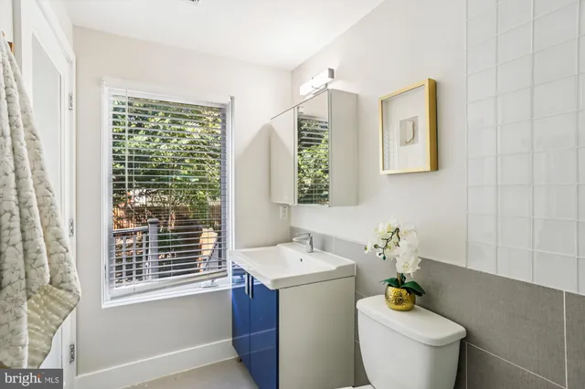 a white toilet sitting next to a bath tub