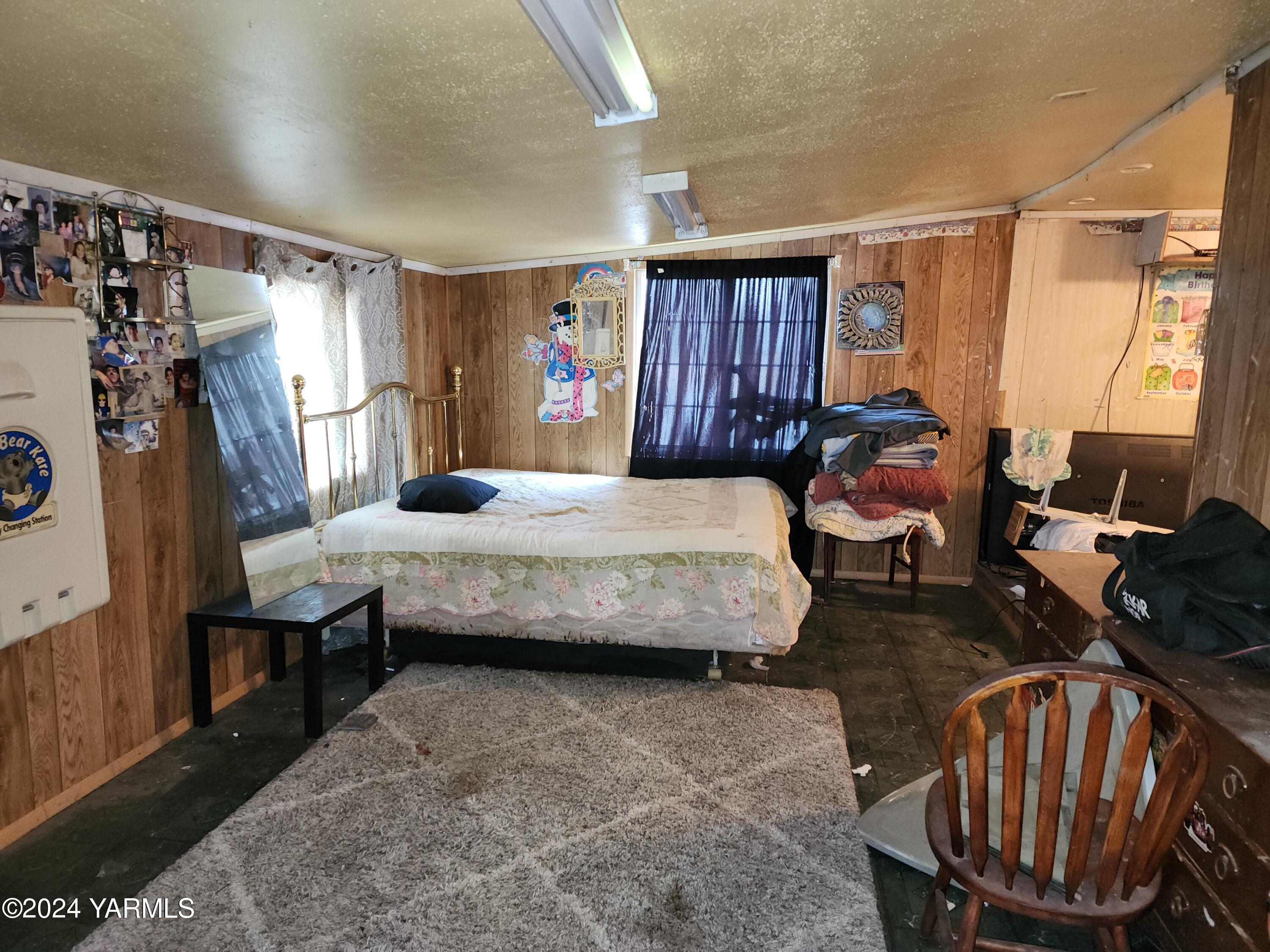 36 East 3rd Avenue Toppenish, WA 98948 - Photo 11 of 20 a bedroom with furniture and a window