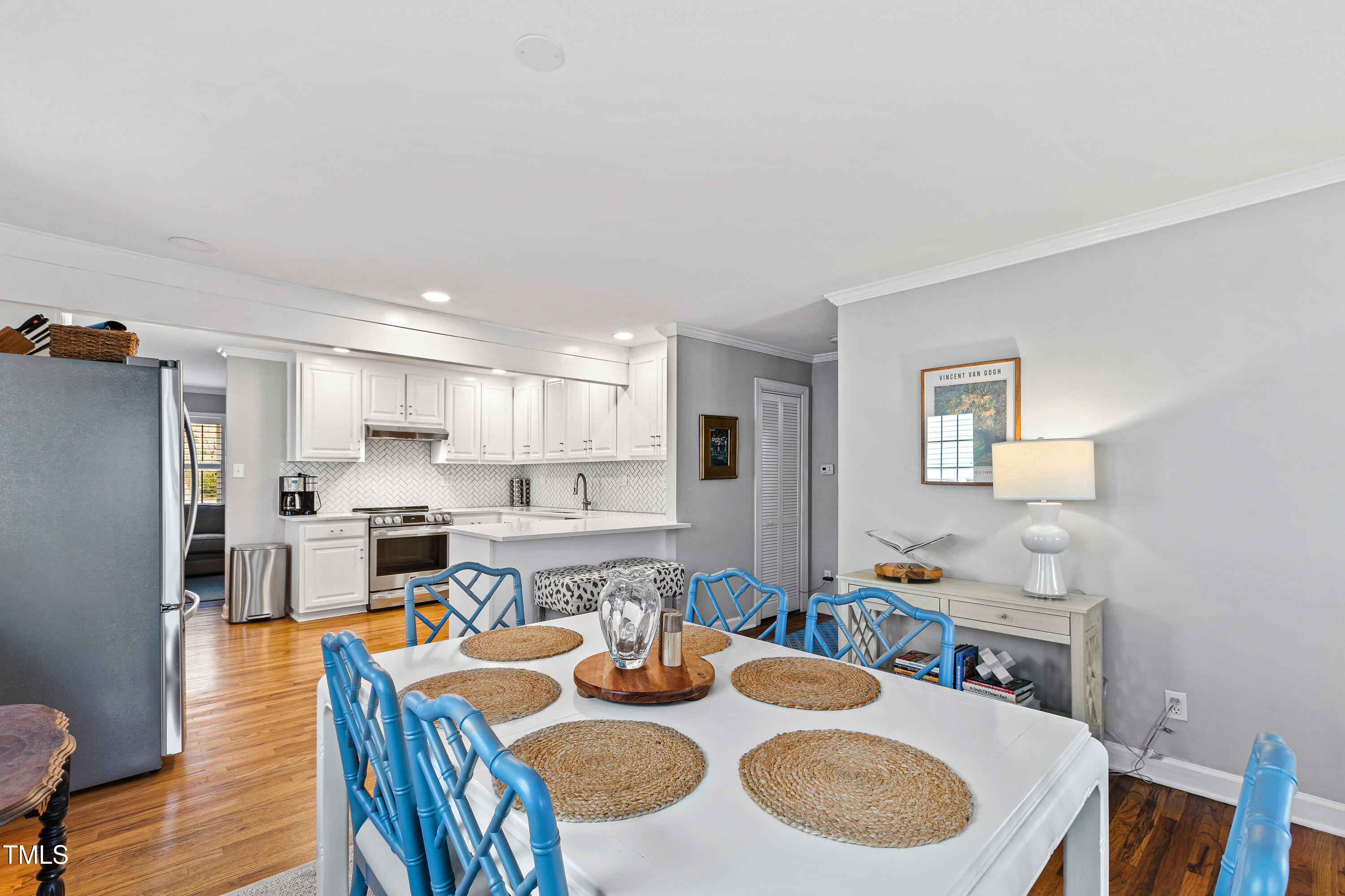 1817 Rankin Street Raleigh, NC 27604 - Photo 12 of 31 a dining room with furniture a wooden floor and a kitchen view