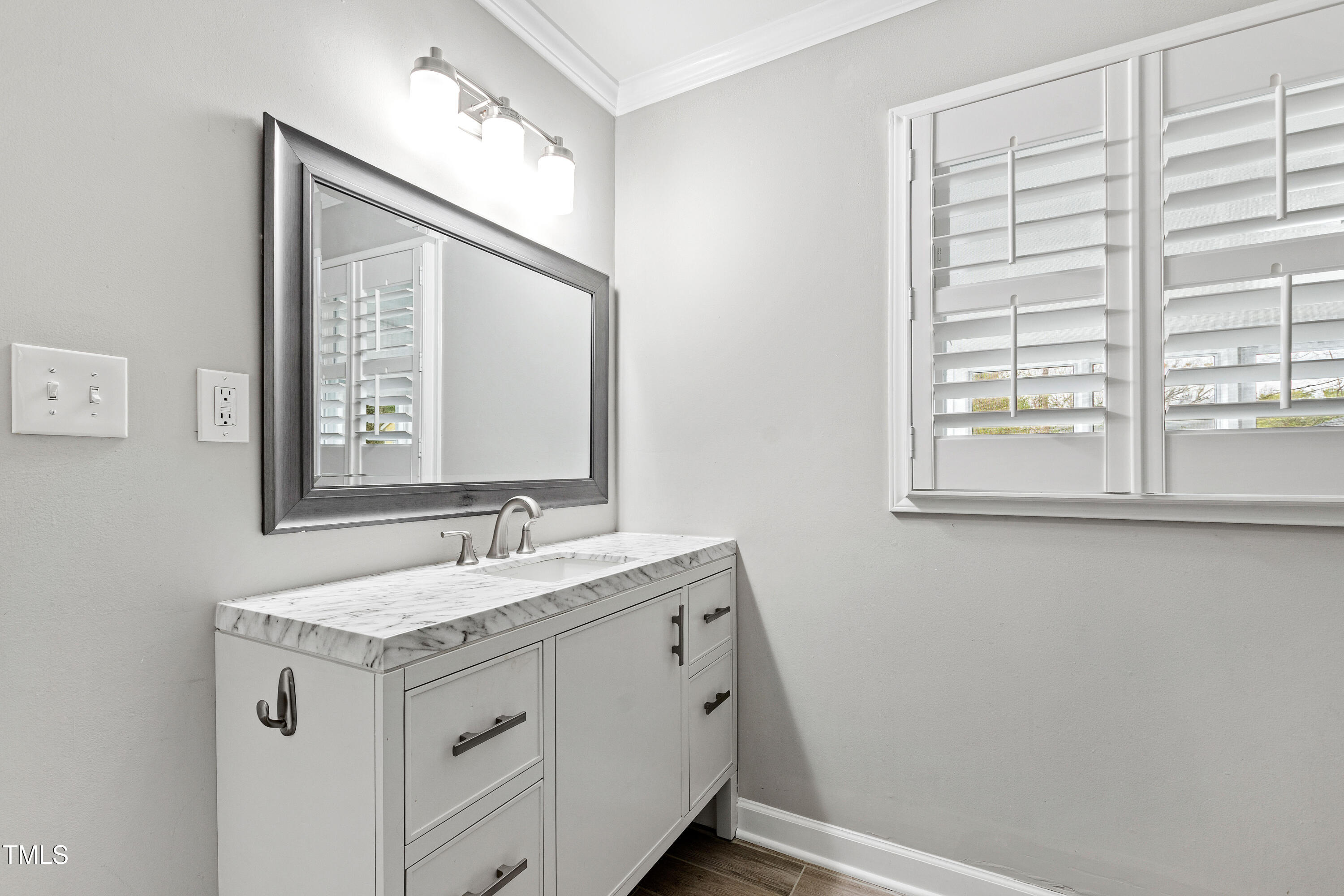 1817 Rankin Street Raleigh, NC 27604 - Photo 16 of 31 a bathroom with a granite countertop sink a mirror and a window