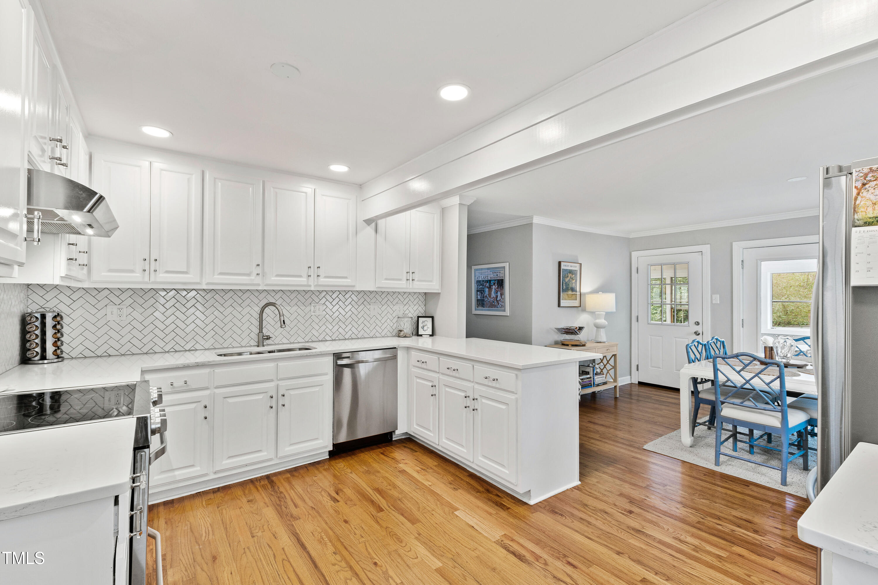 1817 Rankin Street Raleigh, NC 27604 - Photo 6 of 31 a large white kitchen with cabinets and wooden floor