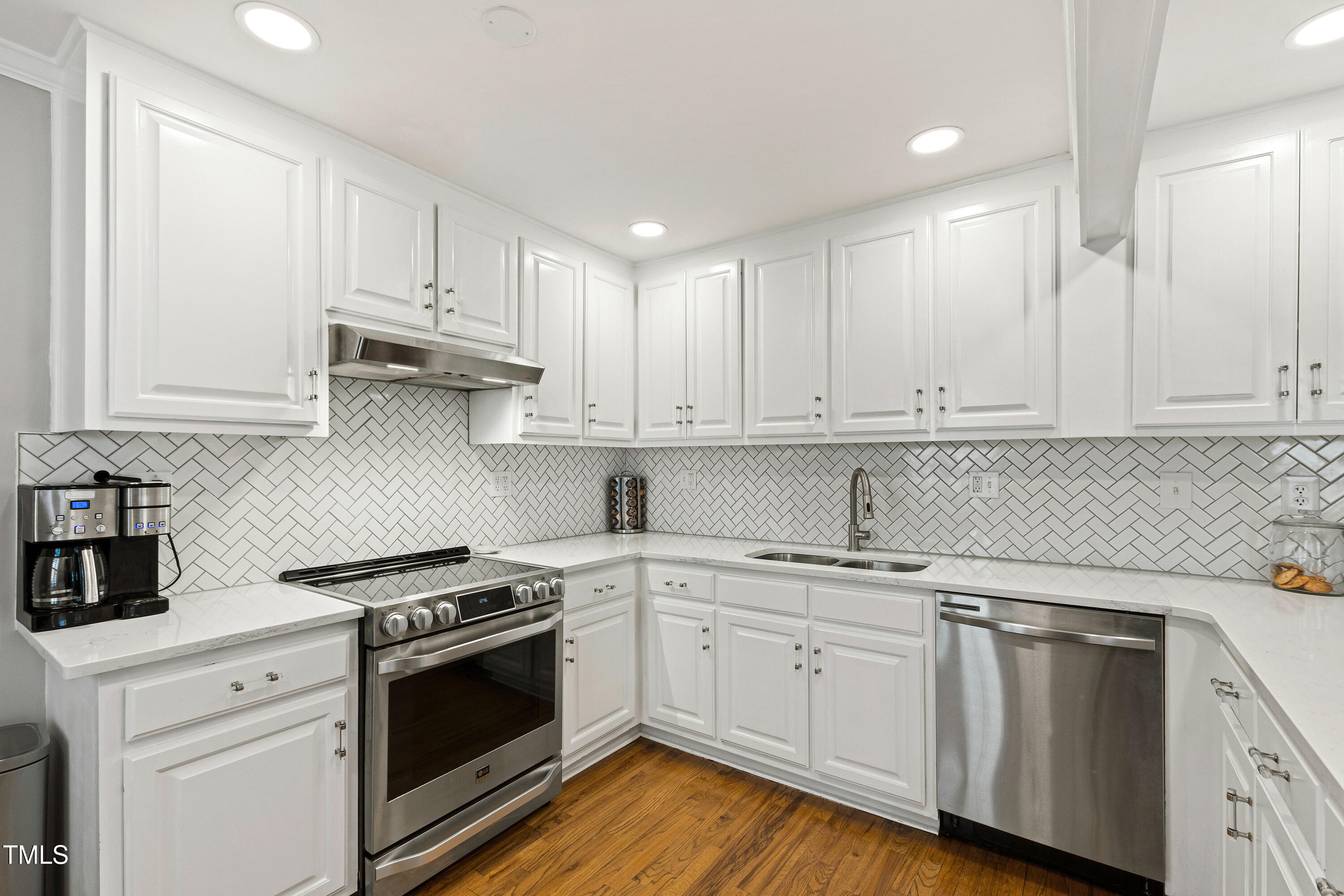 1817 Rankin Street Raleigh, NC 27604 - Photo 7 of 31 a kitchen with cabinets stainless steel appliances a sink and wooden floor