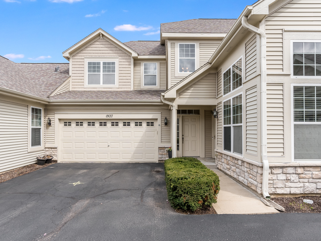 a front view of a house with a garage