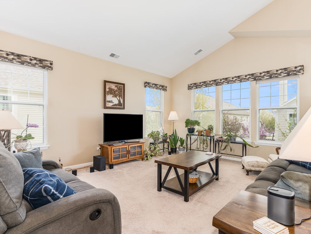 1927 Chase Lane, Unit 1927 Aurora, IL 60502 - Photo 11 of 24 a living room with furniture and a flat screen tv