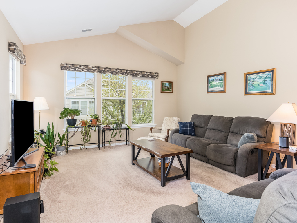 1927 Chase Lane, Unit 1927 Aurora, IL 60502 - Photo 12 of 24 a living room with furniture and a flat screen tv