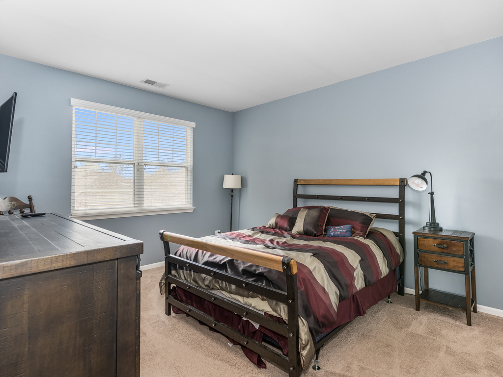 1927 Chase Lane, Unit 1927 Aurora, IL 60502 - Photo 14 of 24 a bedroom with a bed and a window