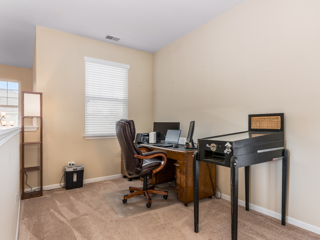 1927 Chase Lane, Unit 1927 Aurora, IL 60502 - Photo 15 of 24 a view of a workspace with furniture and a window