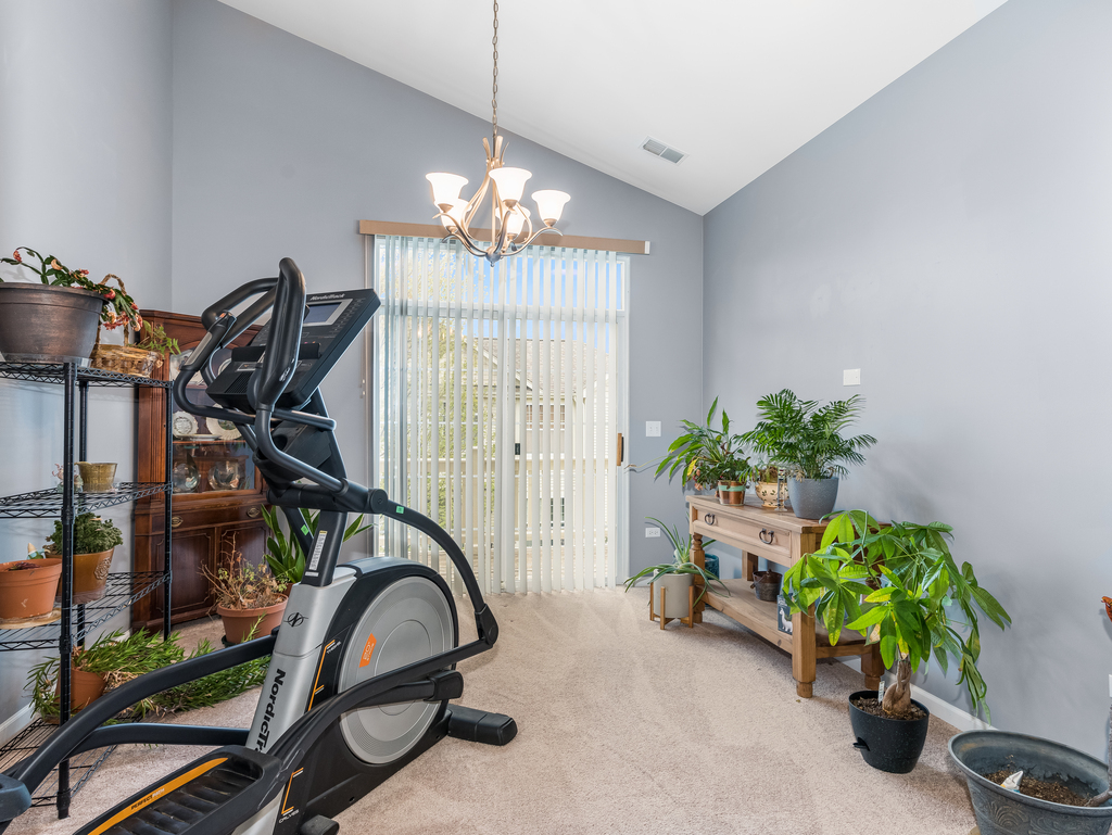 1927 Chase Lane, Unit 1927 Aurora, IL 60502 - Photo 17 of 24 a view of a room with gym equipment
