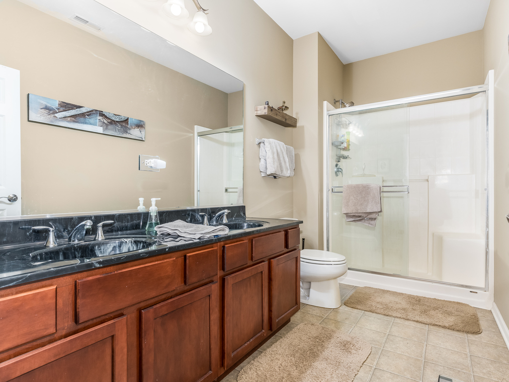 1927 Chase Lane, Unit 1927 Aurora, IL 60502 - Photo 18 of 24 a spacious bathroom with a double vanity sink toilet mirror and shower