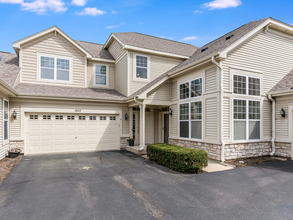 1927 Chase Lane, Unit 1927 Aurora, IL 60502 - Photo 2 of 24 a front view of a house with a garage