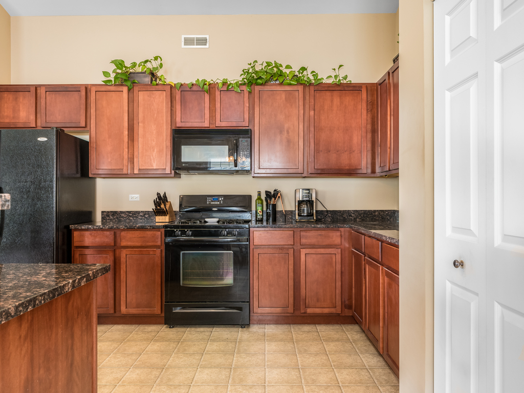 1927 Chase Lane, Unit 1927 Aurora, IL 60502 - Photo 4 of 24 a kitchen with stainless steel appliances granite countertop a stove top oven a sink and dishwasher