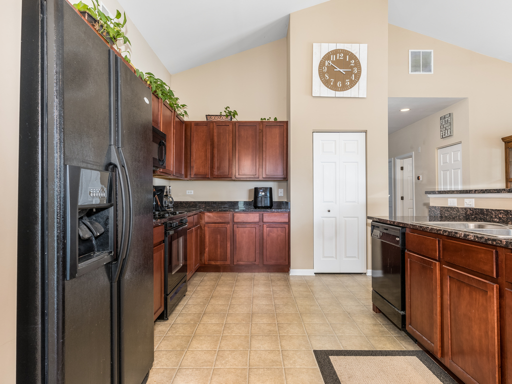 1927 Chase Lane, Unit 1927 Aurora, IL 60502 - Photo 6 of 24 a kitchen with stainless steel appliances granite countertop a refrigerator and a stove