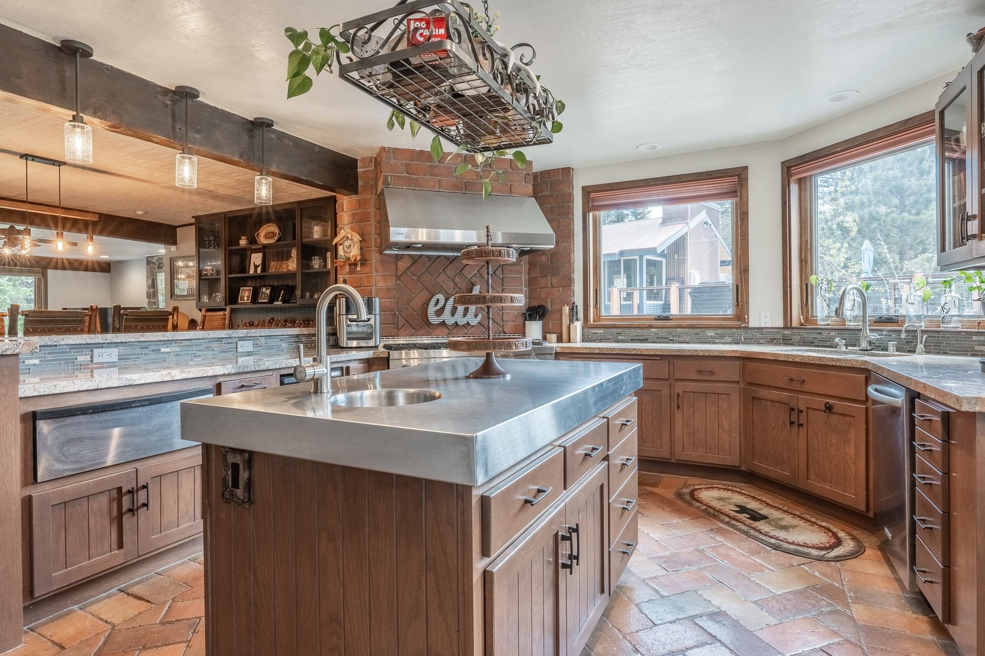 139 Ridgecrest Drive Mammoth Lakes, CA 93546 - Photo 16 of 65 Kitchen featuring a substantial island with a stainless steel countertop and integrated sink