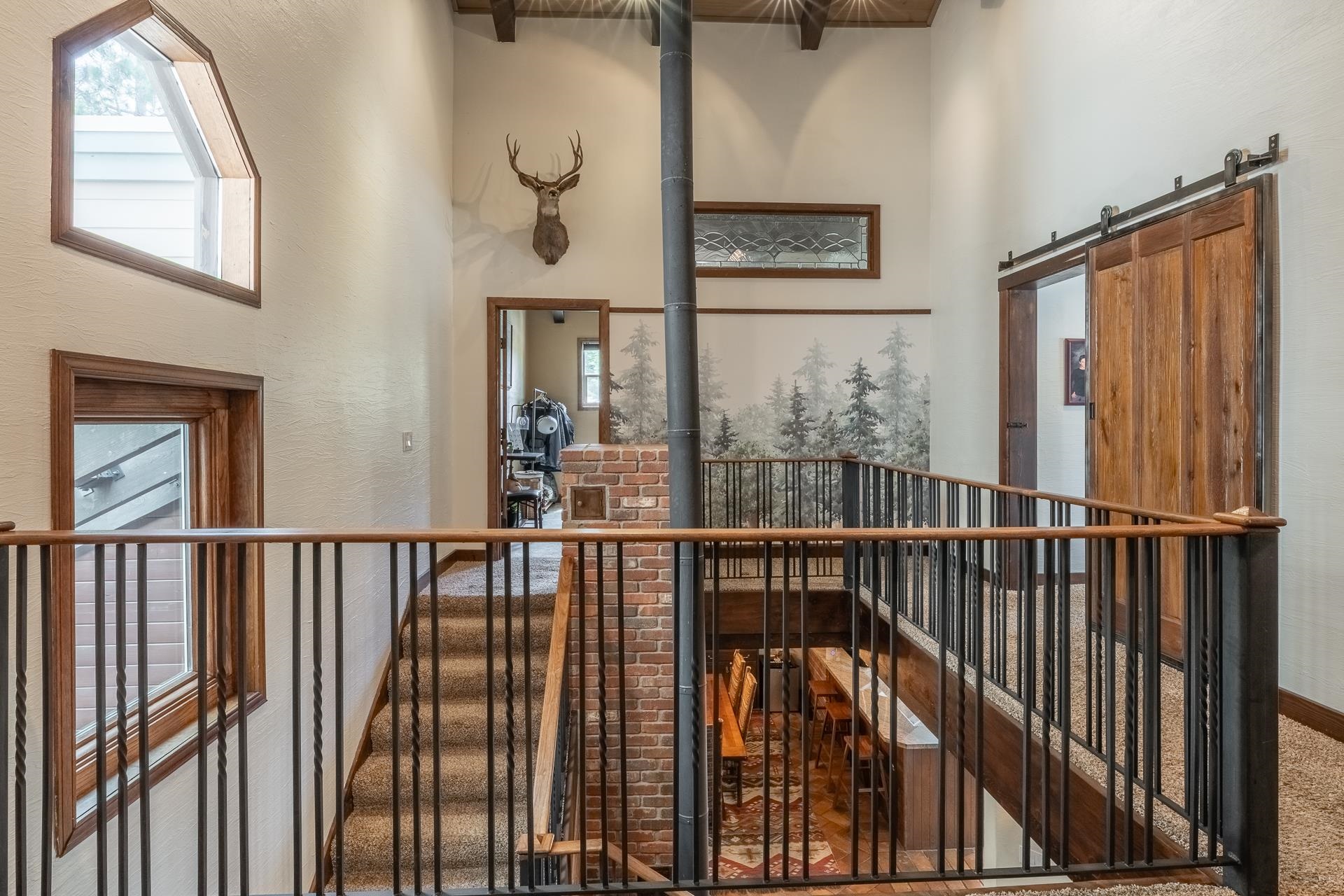 139 Ridgecrest Drive Mammoth Lakes, CA 93546 - Photo 40 of 65 Upper-level landing/hallway featuring a wood-finish handrail, black iron balusters