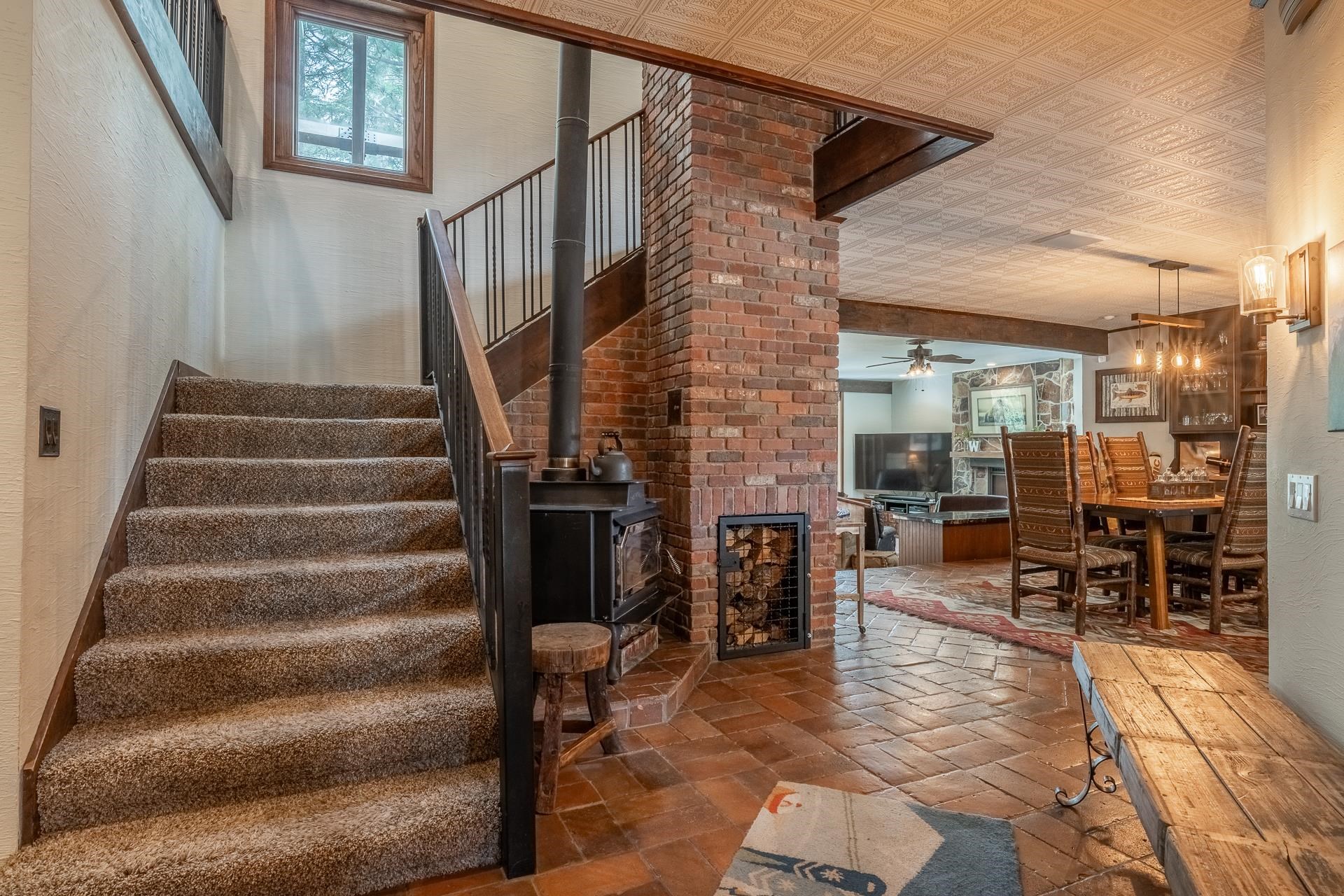 139 Ridgecrest Drive Mammoth Lakes, CA 93546 - Photo 51 of 65 Entry off of mudroom featuring a wood-burning stove with brick surround and dumbwaiter