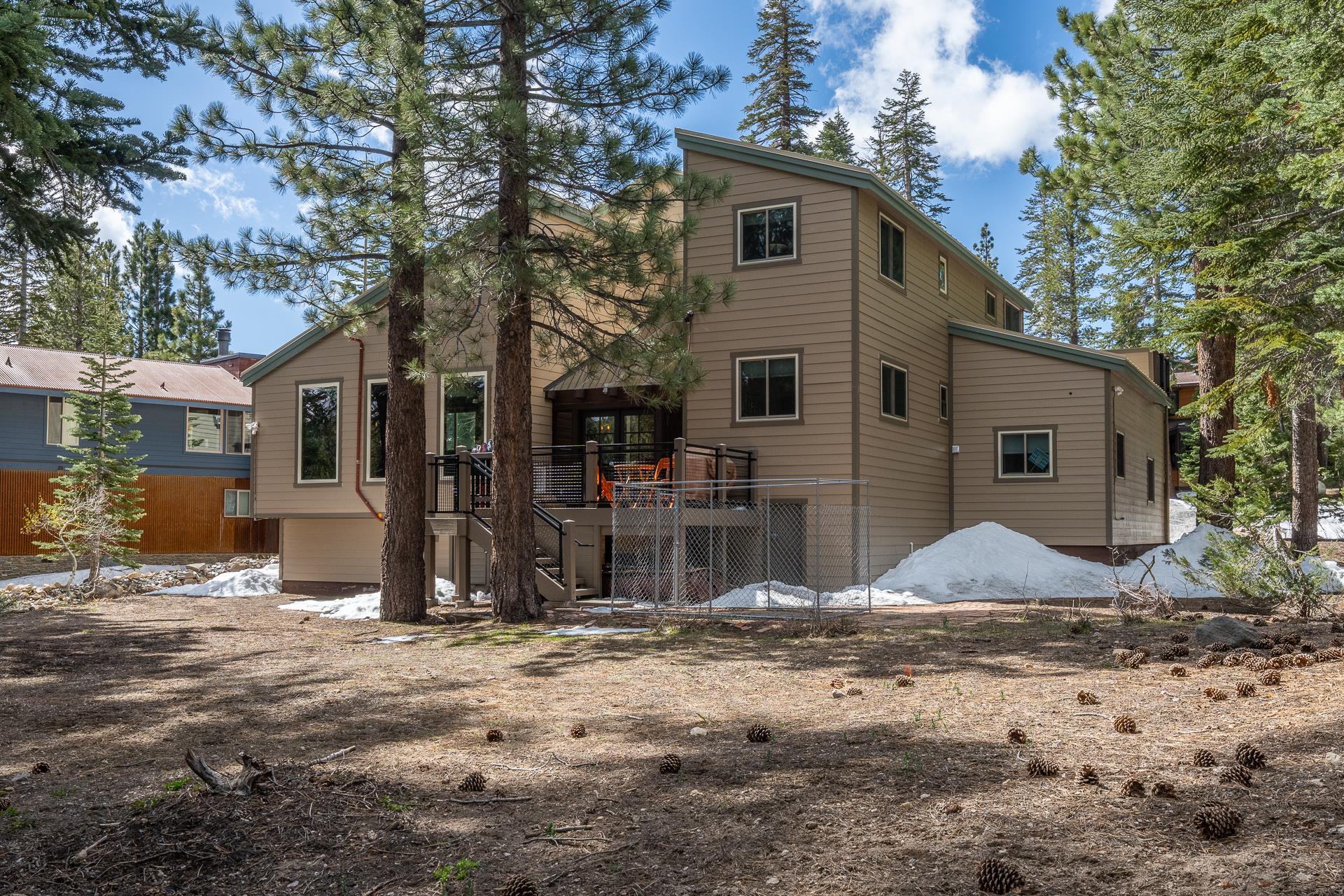 139 Ridgecrest Drive Mammoth Lakes, CA 93546 - Photo 63 of 65 Multi-level exterior with tan horizontal siding, multiple windows, and a dark-railed deck