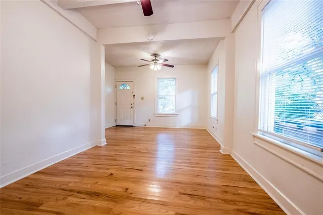 wooden floor in an empty room with a window