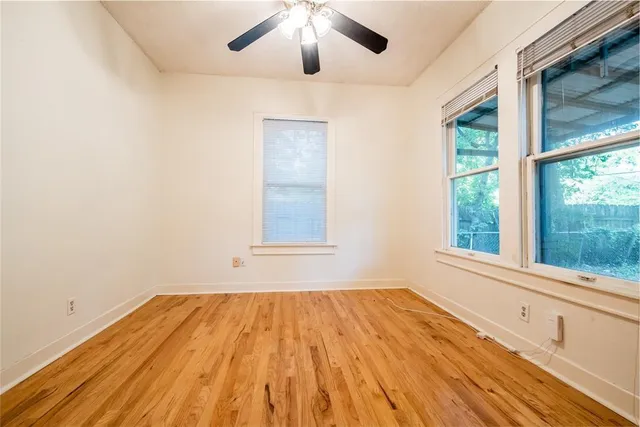 a view of a room with wooden floor and windows