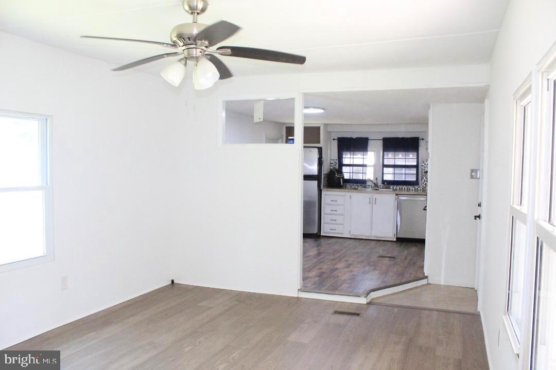 1762 Crown Point Road, Unit 2310B West Deptford, NJ 08086 - Photo 4 of 39 a view of a kitchen with a microwave and a ceiling fan