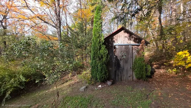 a view of a house with large trees and plants
