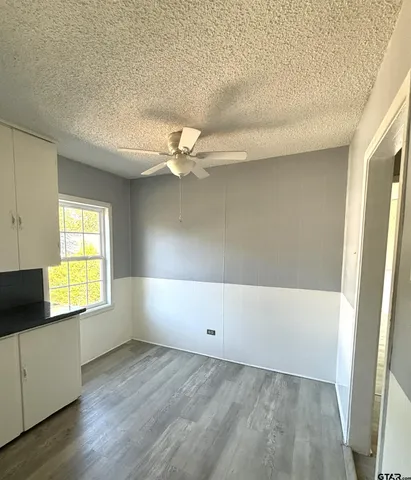 a view of an empty room and a window