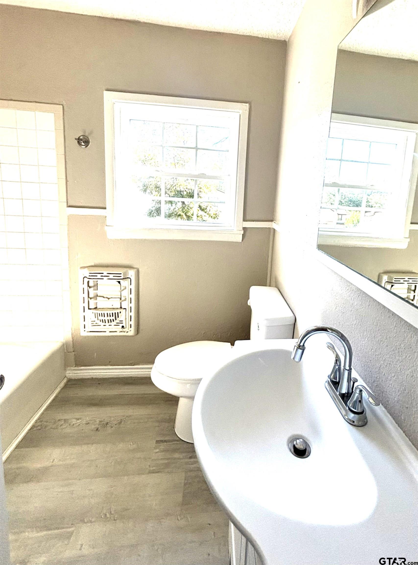 1511 Summit Avenue, Unit 3 Tyler, TX 75702 - Photo 5 of 8 a bathroom with a sink and a toilet