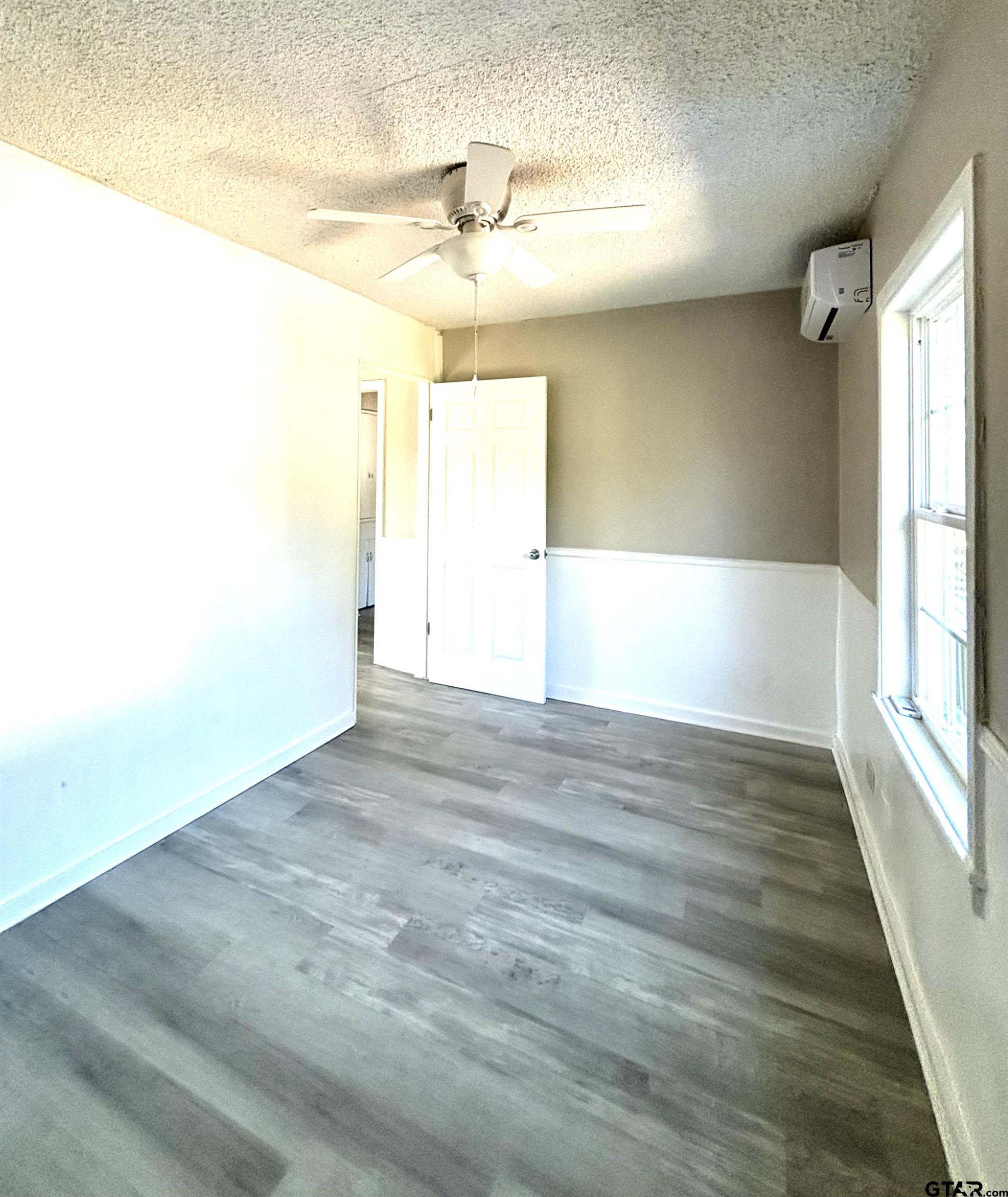 1511 Summit Avenue, Unit 3 Tyler, TX 75702 - Photo 6 of 8 a view of empty room with wooden floor and fan