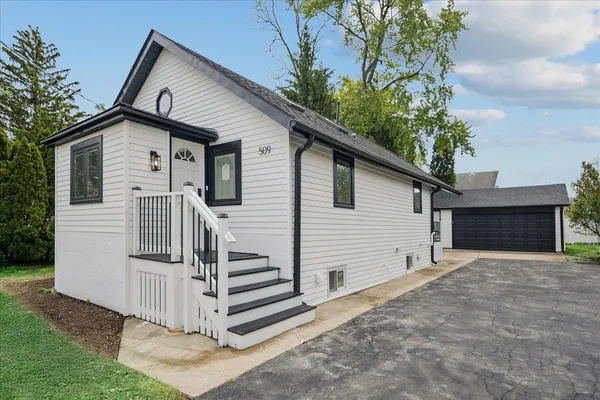 a view of a house with a yard and garage