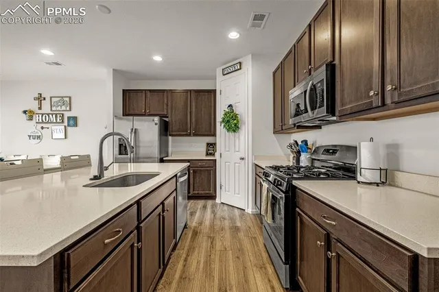 a kitchen with granite countertop stainless steel appliances and sink