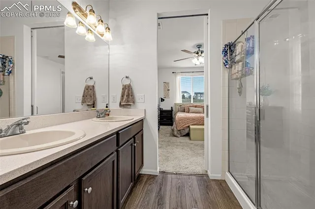 a en suite bathroom with a granite countertop sink and a mirror
