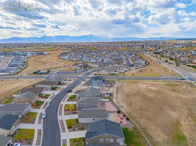an aerial view of a house with a yard