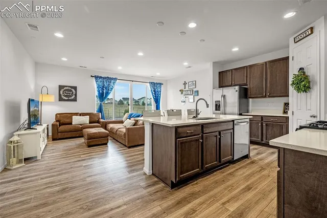 a kitchen with sink a microwave and cabinets