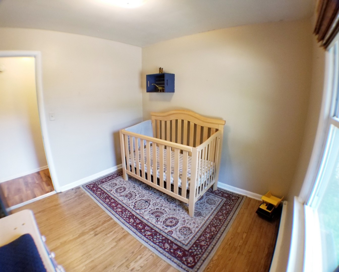 85 River Bluff Road Elgin, IL 60120 - Photo 19 of 26 a view of an empty room with wooden floor and a window