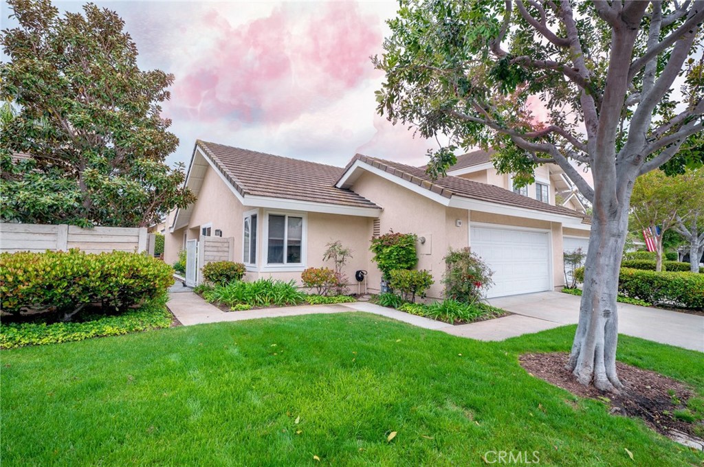 a front view of house with a garden and patio