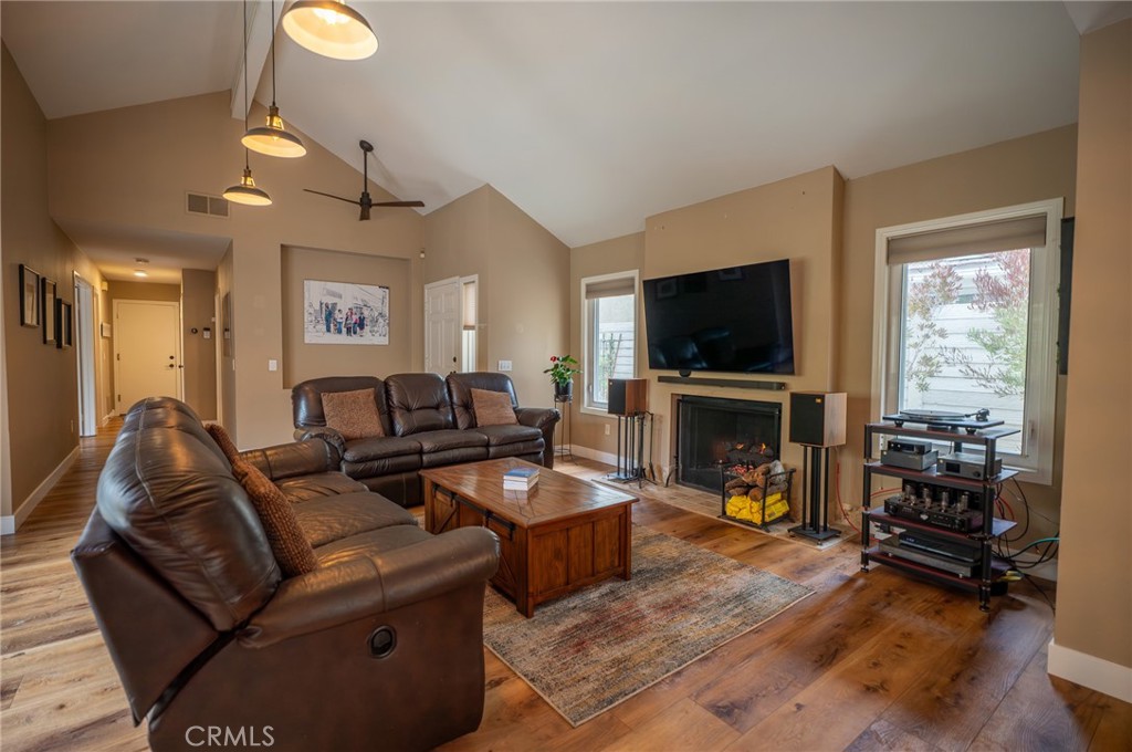 19 Windsong Irvine, CA 92614 - Photo 15 of 46 a living room with furniture a fireplace a flat screen tv and a large window