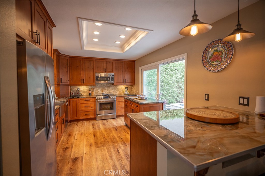 19 Windsong Irvine, CA 92614 - Photo 19 of 46 a kitchen with stainless steel appliances granite countertop a sink a stove and a refrigerator