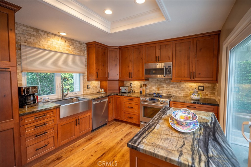 19 Windsong Irvine, CA 92614 - Photo 22 of 46 a kitchen with granite countertop lots of counter top space and wooden floor