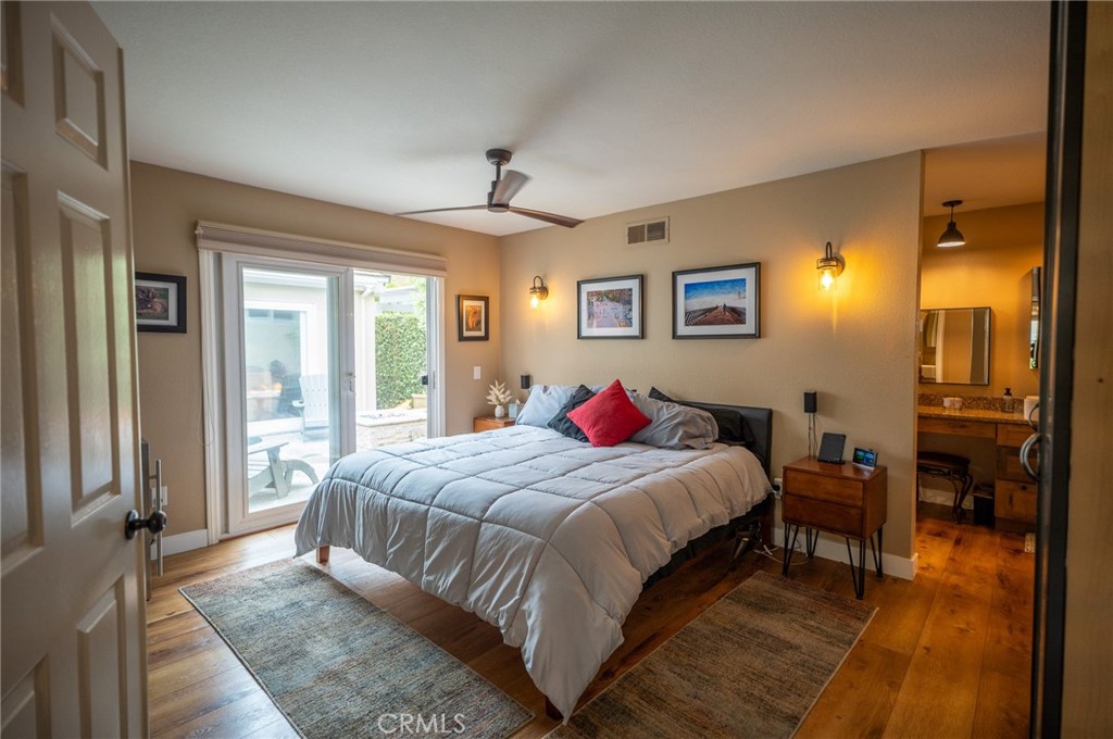 19 Windsong Irvine, CA 92614 - Photo 28 of 46 a bedroom with a large bed and a chandelier