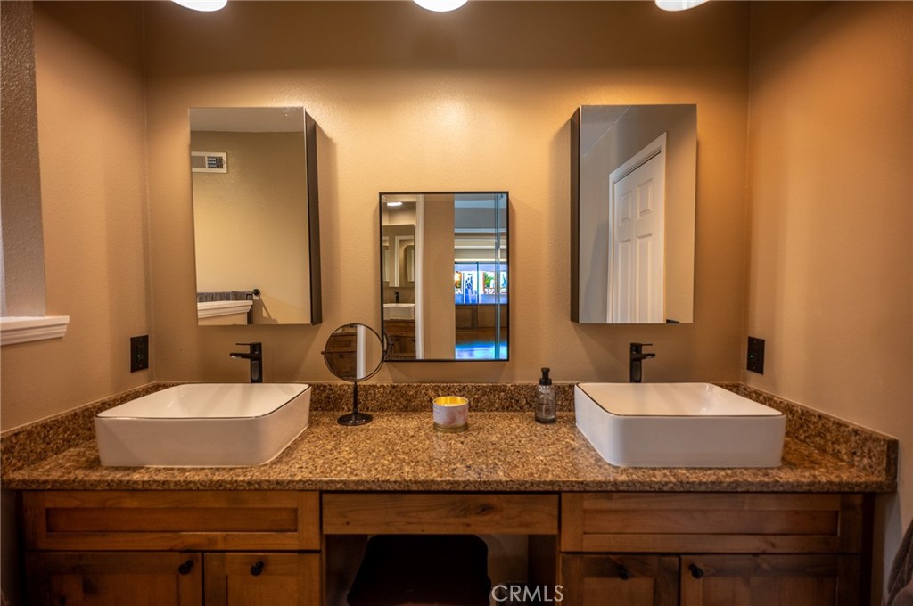 19 Windsong Irvine, CA 92614 - Photo 32 of 46 a bathroom with double vanity sinks granite tub and a mirror