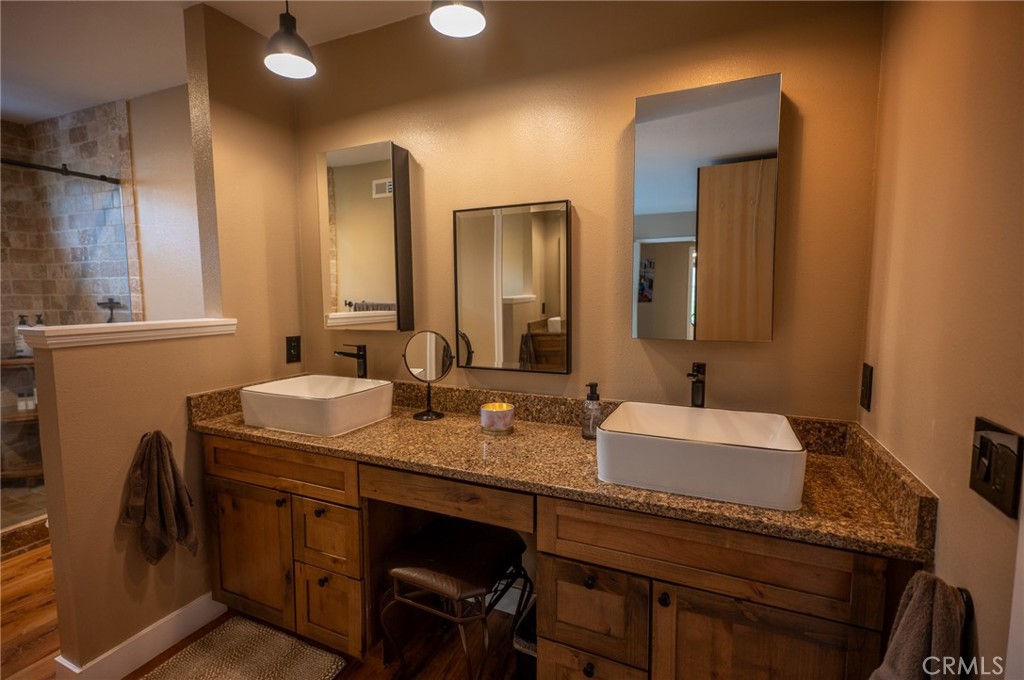 19 Windsong Irvine, CA 92614 - Photo 33 of 46 a bathroom with a granite countertop sink and a mirror