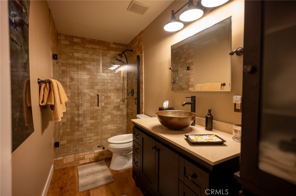 19 Windsong Irvine, CA 92614 - Photo 38 of 46 a bathroom with a sink a toilet a mirror and shower